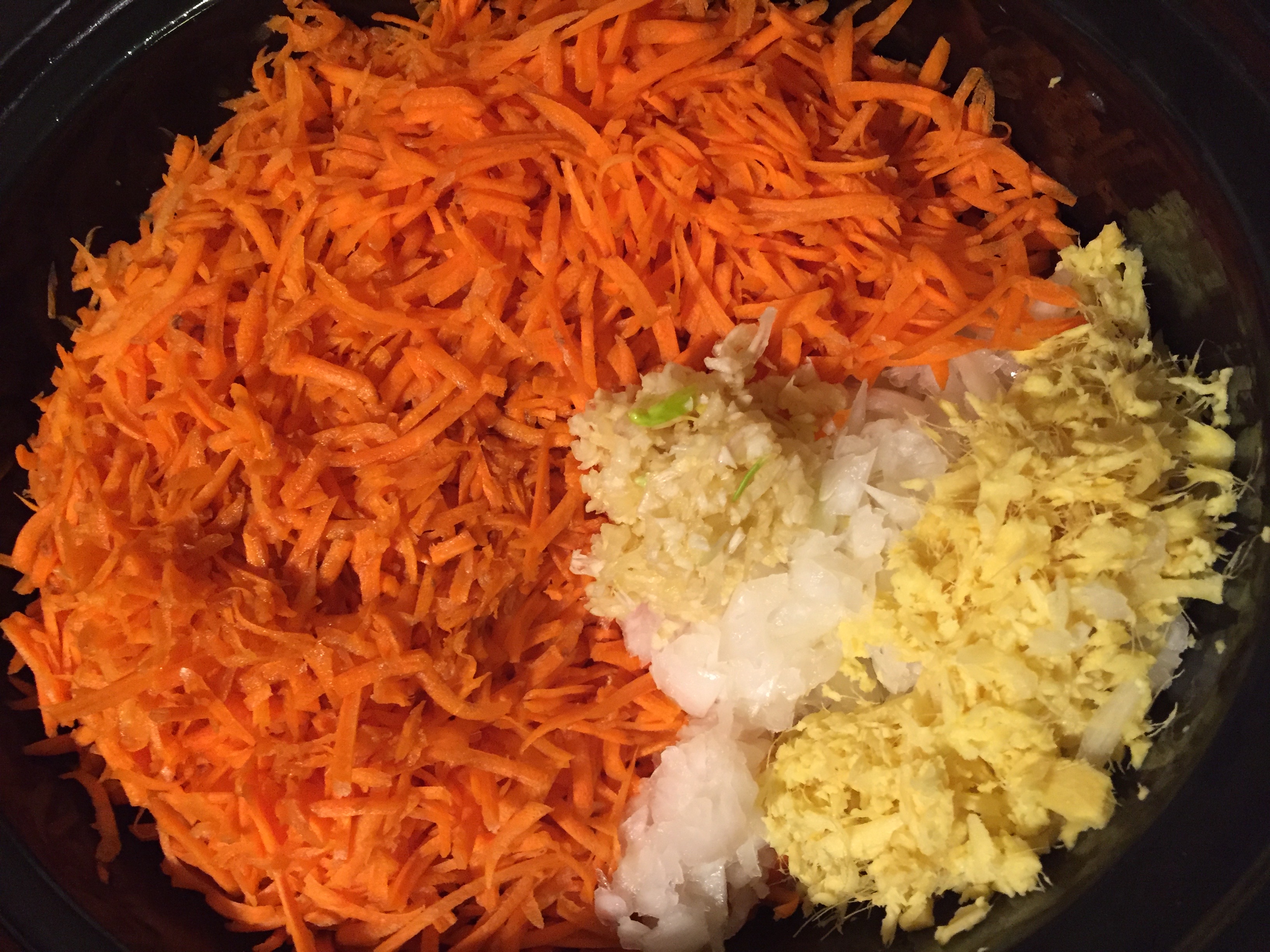 Shredded carrot, garlic, ginger, and onion prepped for curried lentil soup