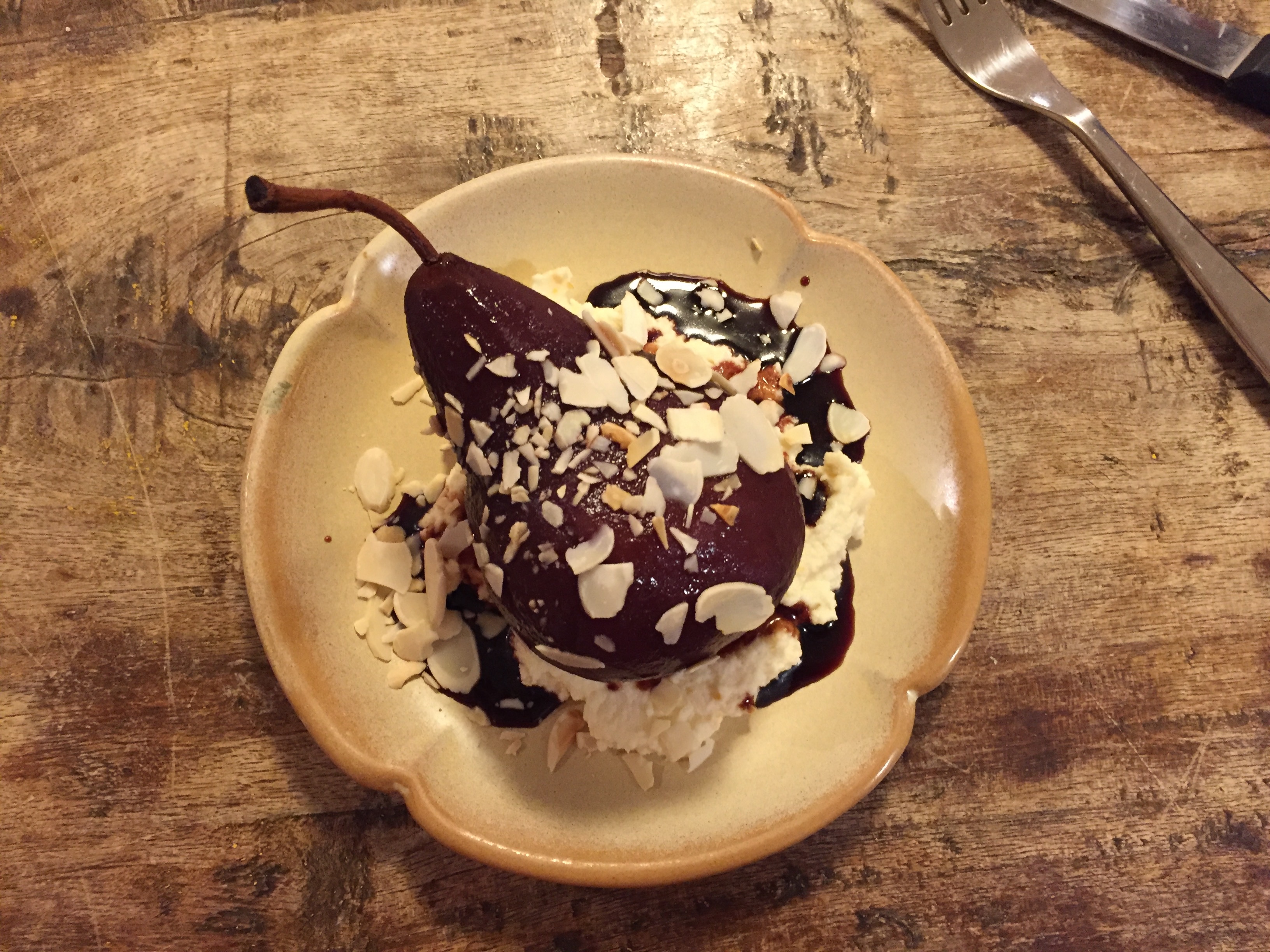 Poached pear with mascarpone, chocolate, and toasted almonds